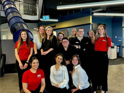 FC STUDENTS STANDING BY SLIDE