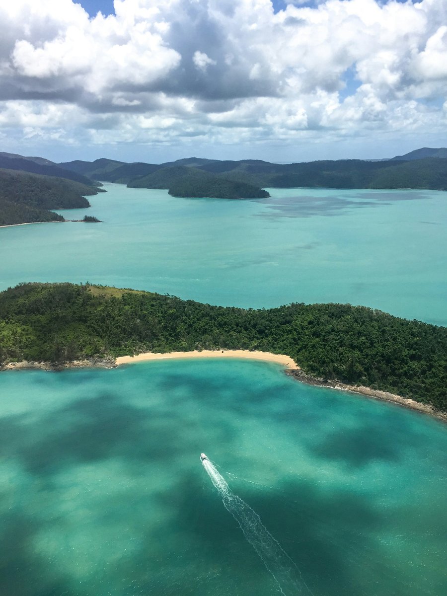 A drone shot of the stunning turquoise blue waters of the Whitsundays