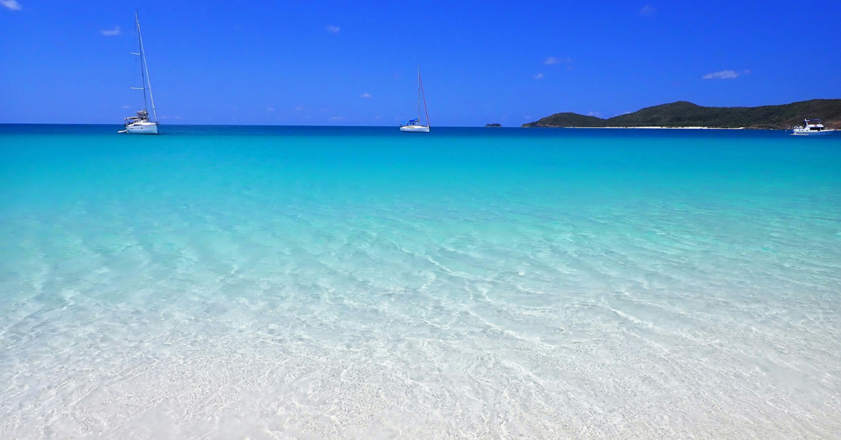 Crystal clear blue water on a beach in the Whitsundays